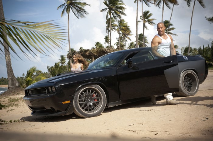 Vin Diesel and a woman with a car on a beach