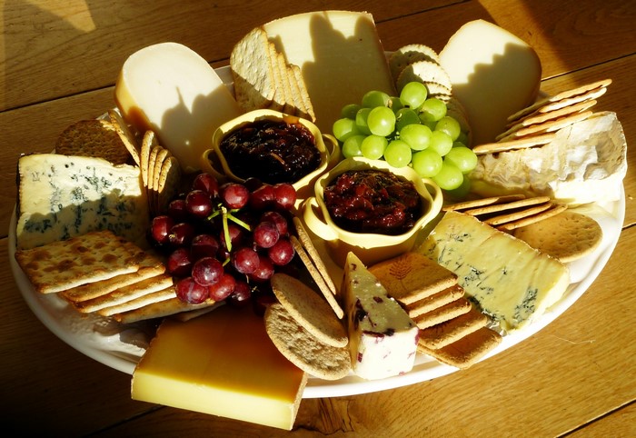 Cheese board with grapes and crackers