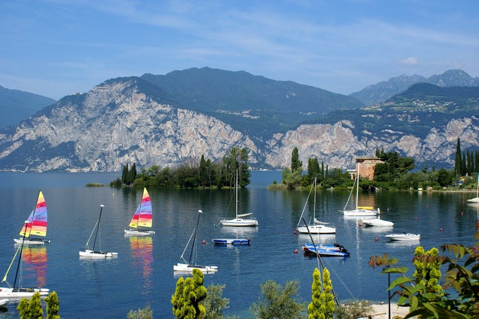 Sailboats on a lake with mountains in the background