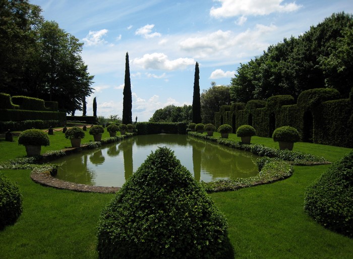 Formal garden with a pond and manicured hedges