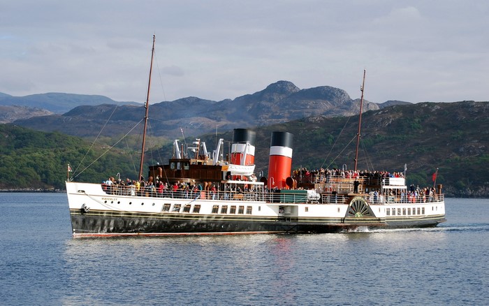 Paddle Steamer Waverley sailing on water with mountains