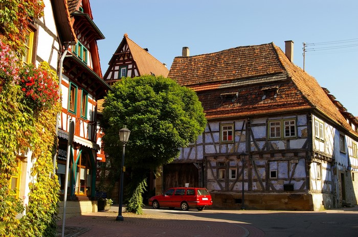 Half-timbered houses and a red car in Oberderdingen, Germany