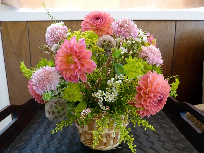 Pink and coral dahlias in a basket bouquet