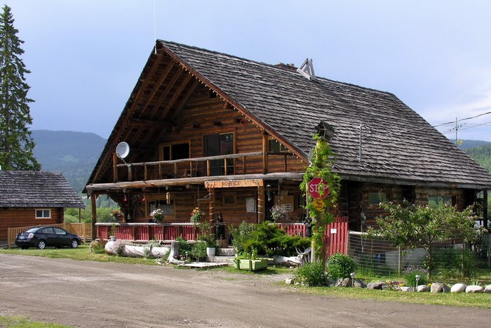 Log cabin lodge with a stop sign in Canada
