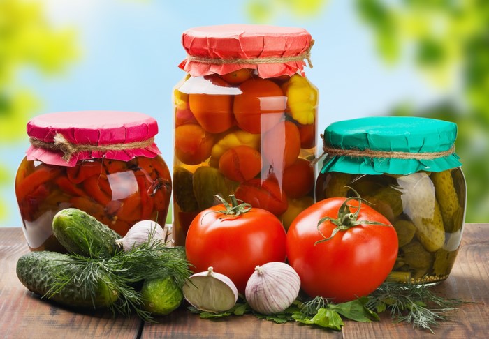 Jars of Pickled Vegetables and Fresh Produce