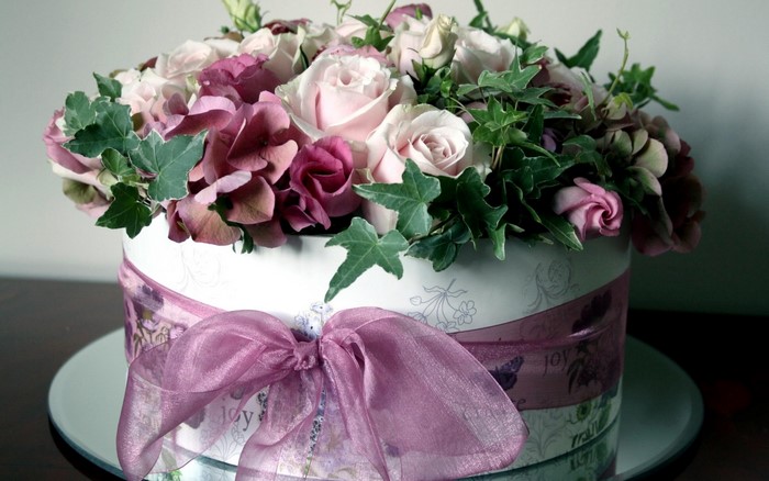 Floral arrangement in a decorative box with a bow