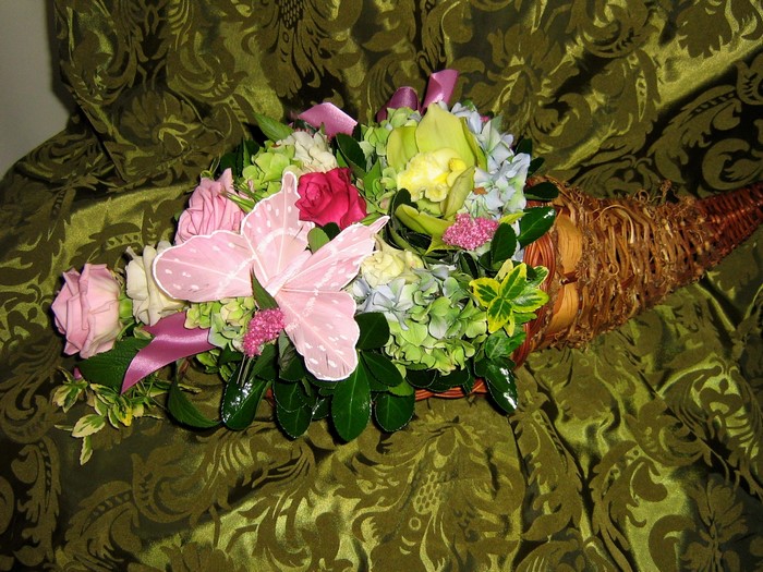 Cornucopia flower arrangement with pink butterfly