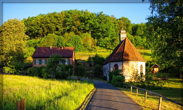 Chapel and house in a green landscape, Germany