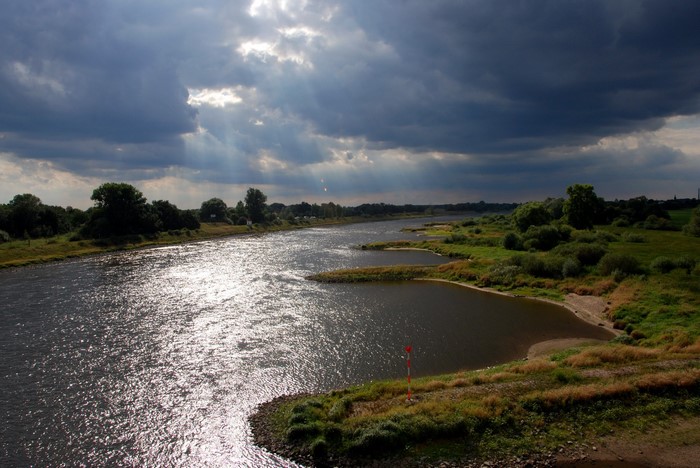 River with sunbeams through clouds