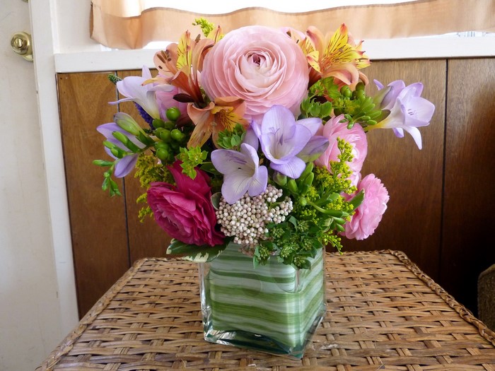 Floral arrangement in a square glass vase