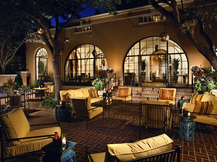 Outdoor patio seating area with arched windows