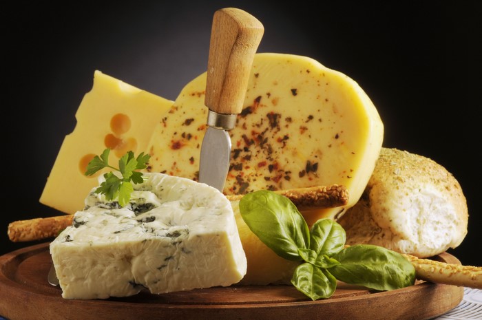 Cheese platter with breadsticks and herbs