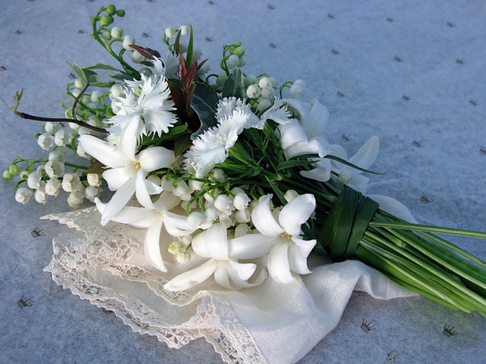 White flower bouquet with lace and greenery