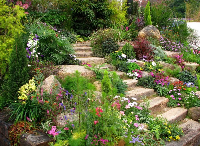 A beautiful garden with stone steps and colorful flowers