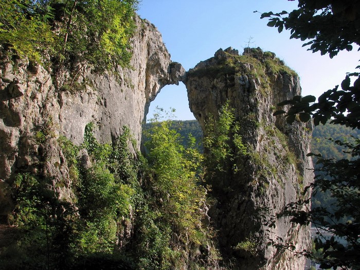 Natural rock archway between two cliffs