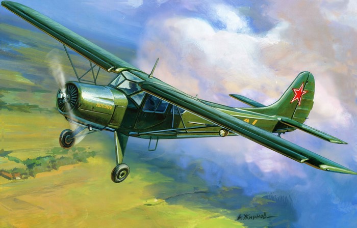 Green biplane in flight over a landscape