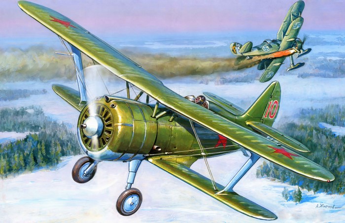 Two biplanes in flight over a snowy landscape