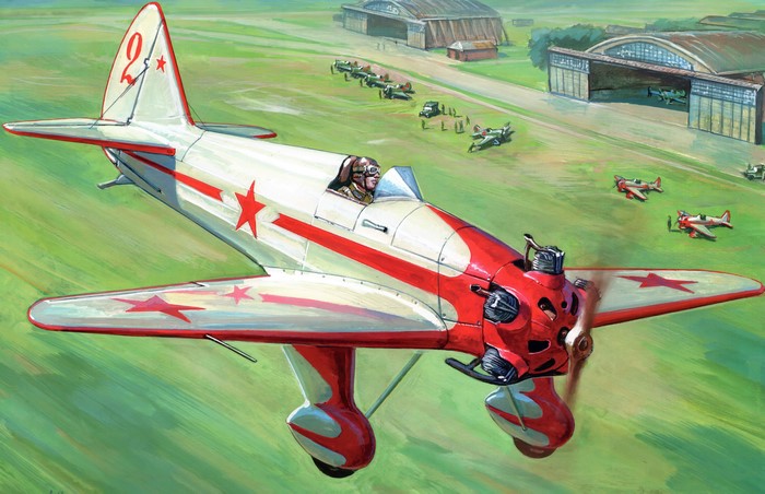 Red and white airplane with red stars flying over a field with hangars