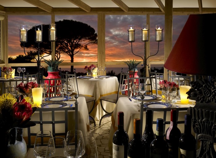 Restaurant dining tables set for dinner at sunset