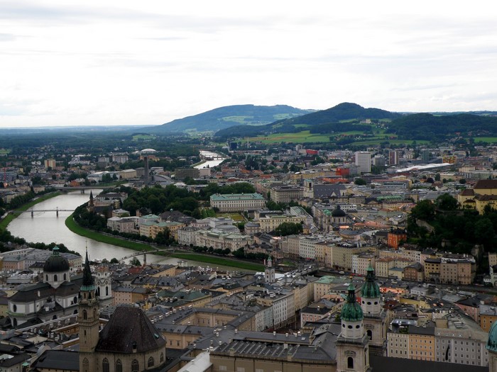 Salzburg cityscape with river and mountains, Austria