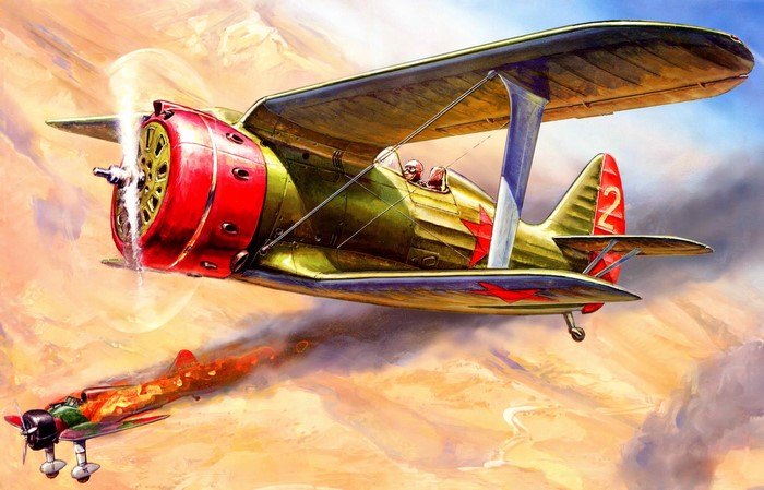 Biplane attacking a burning bomber aircraft