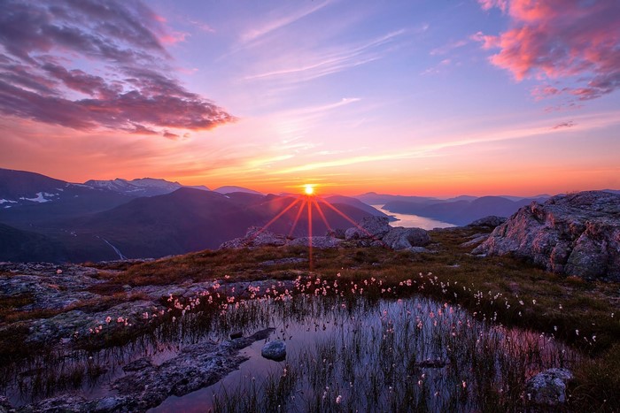 Sunset over mountains and a lake