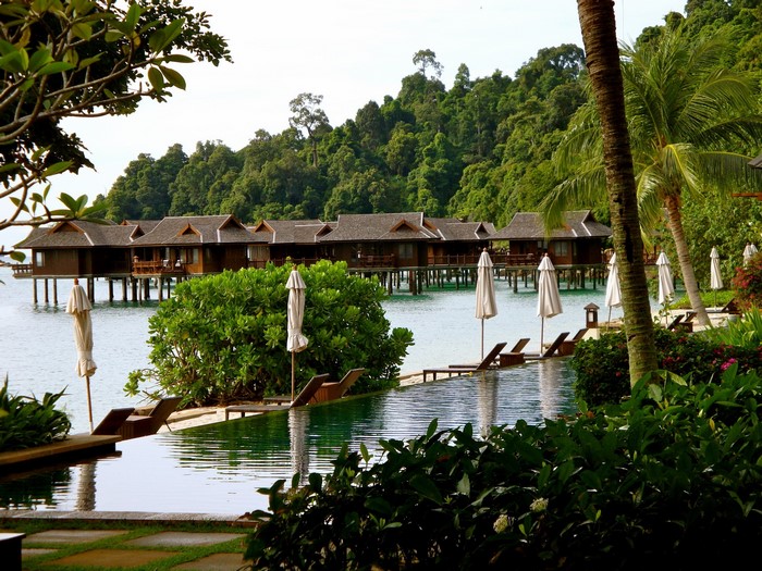 Tropical resort with overwater bungalows and infinity pool