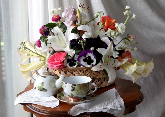 Flower bouquet with tea set on a table