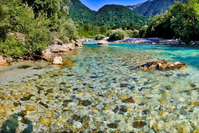 Clear river flowing through a mountainous landscape