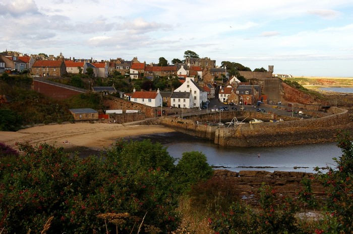 Coastal village with harbor and castle in Scotland