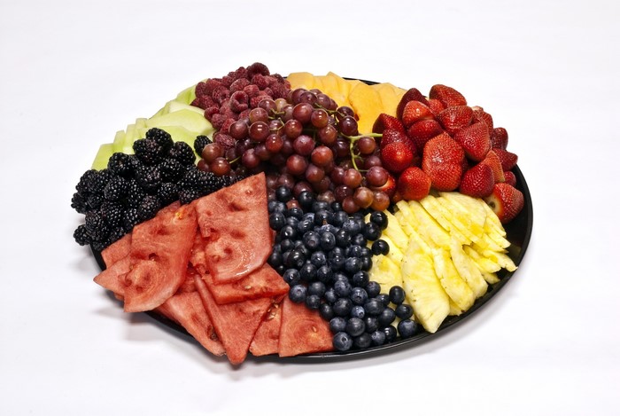 Fruit platter with strawberries, grapes, blueberries, pineapple, watermelon, cantaloupe, blackberries, and raspberries