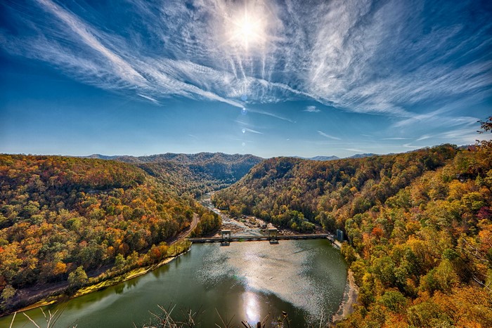 Dam on a River Surrounded by Autumn Forest