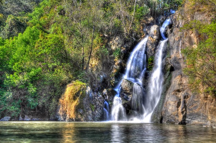 Waterfall cascading over rocks in a lush forest