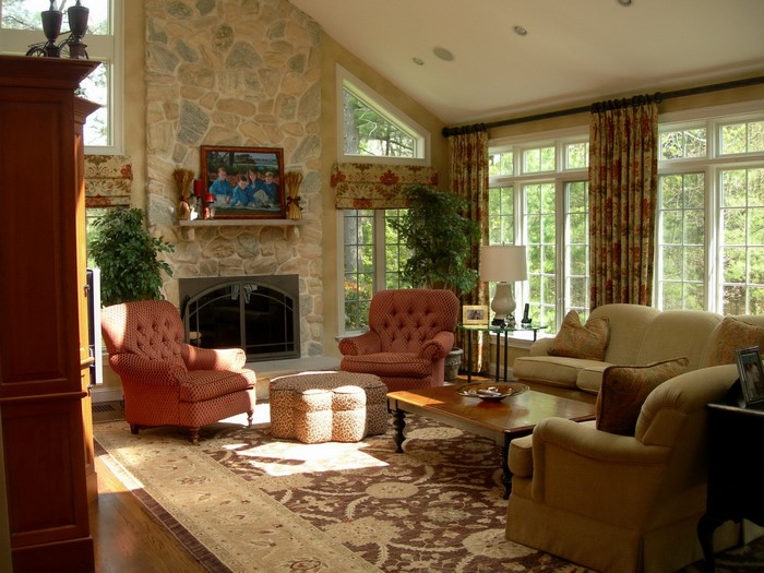 Living room with stone fireplace and large windows