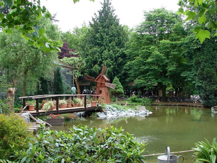 Park with pond, bridge, and windmill