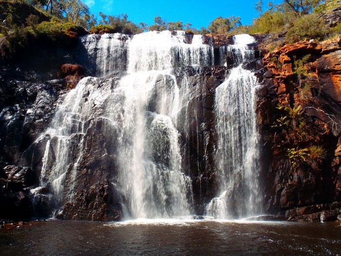 Waterfall cascading over dark rocks