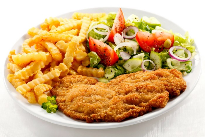 Breaded chicken cutlet with french fries and salad