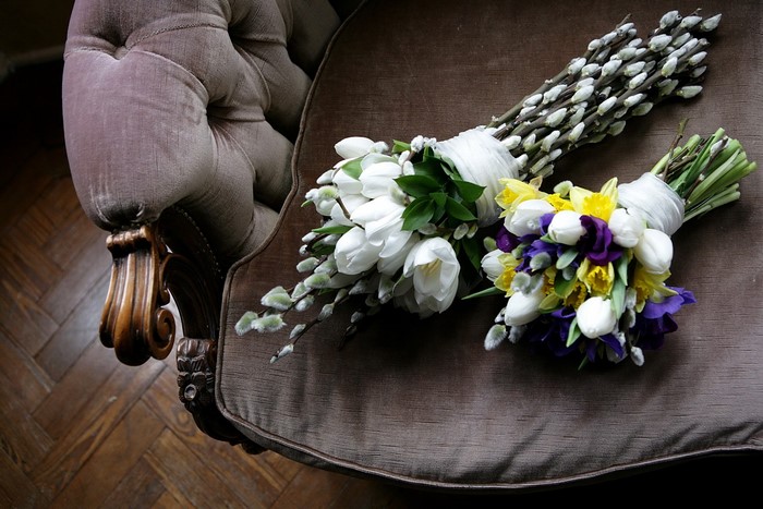 Two bouquets of flowers on a chair