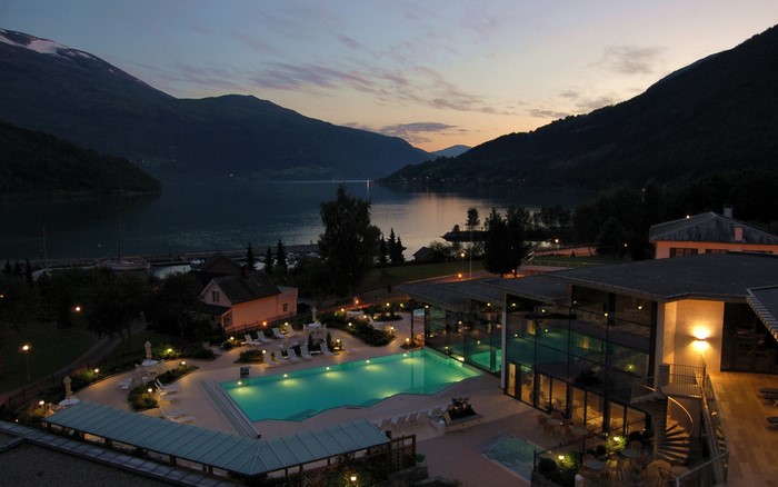 Resort with pool and lake in Norway at dusk