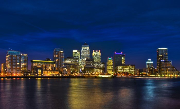 City skyline at night with reflections on water