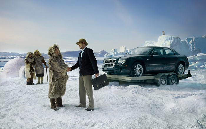 Man in suit shakes hands with Inuit man in arctic