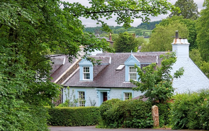 Light blue house with dormer windows in Scotland