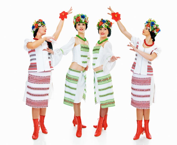 Four women in traditional Ukrainian costumes dancing