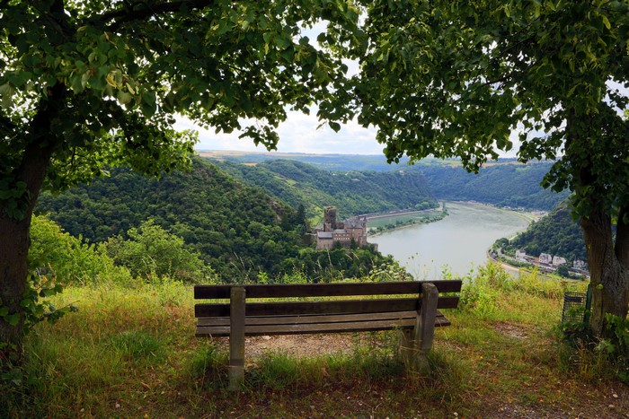 Bench overlooking a river and castle