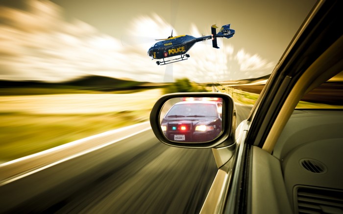 Police helicopter and police car in pursuit