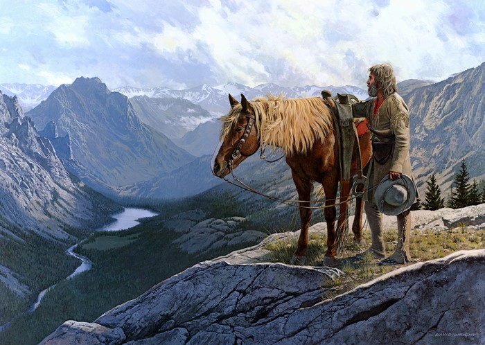 Man and horse overlooking a mountain valley