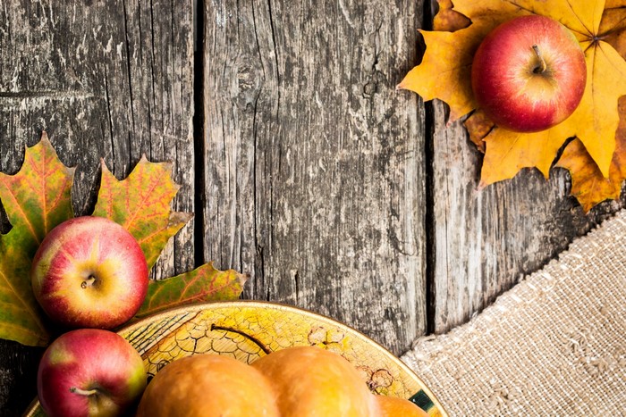 Apples and Autumn Leaves on Wooden Table