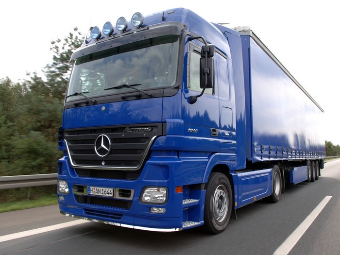 Blue Mercedes-Benz Actros Semi-Truck Driving on Highway