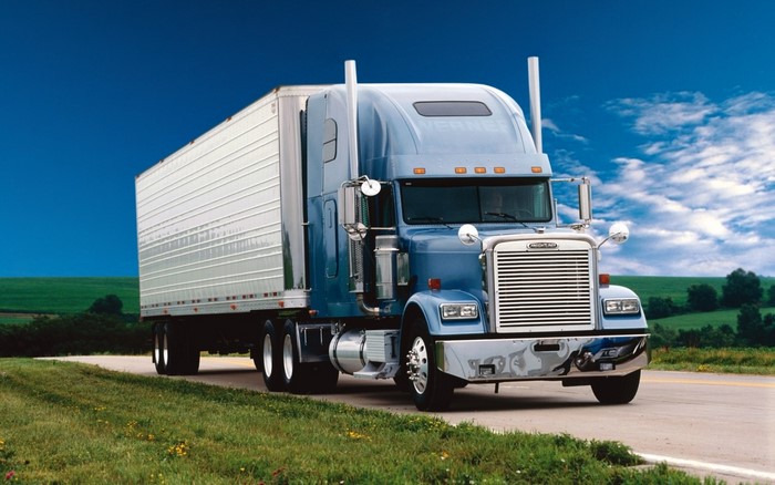 Blue Freightliner Truck with Trailer on Road