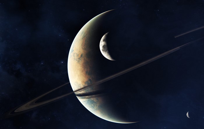 Ringed planet with moons in space
